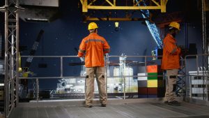 Worker hard hat conducts system inspections offshore drilling rig from industrial platform 300x169
